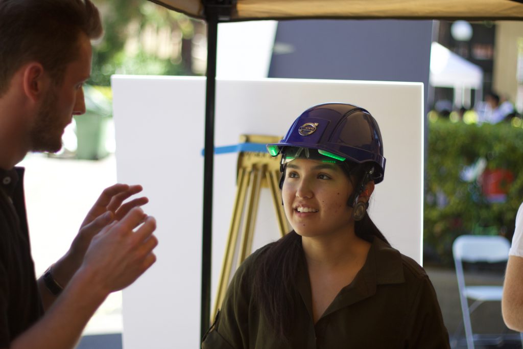 Guest at Volvo booth trying the hard hat.